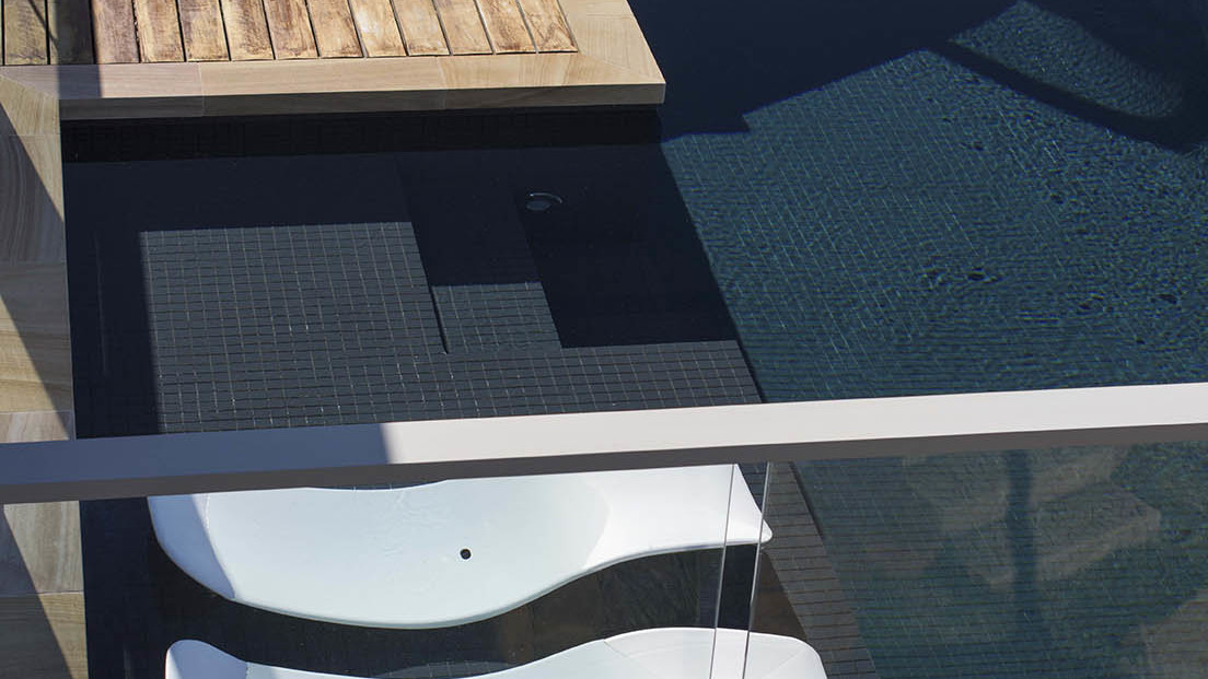 View of pool, sun chairs and decking